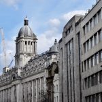 A row of buildings down the right-hand side of a road (the road is out of shot). The