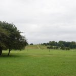 A small hillock within a park, which is mostly deserted.