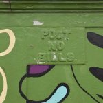 A bridge wall, painted mostly green with curvy abstract detailing in black, yellow, purple and sky blue. Also overpainted is a metal sign attached to the bridge panelling, which reads “POST NO BILLS”.