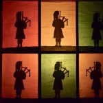 Six silhouettes of pipers against six window panes, covered in different colours of translucent paper (red, orange, yellow and green).